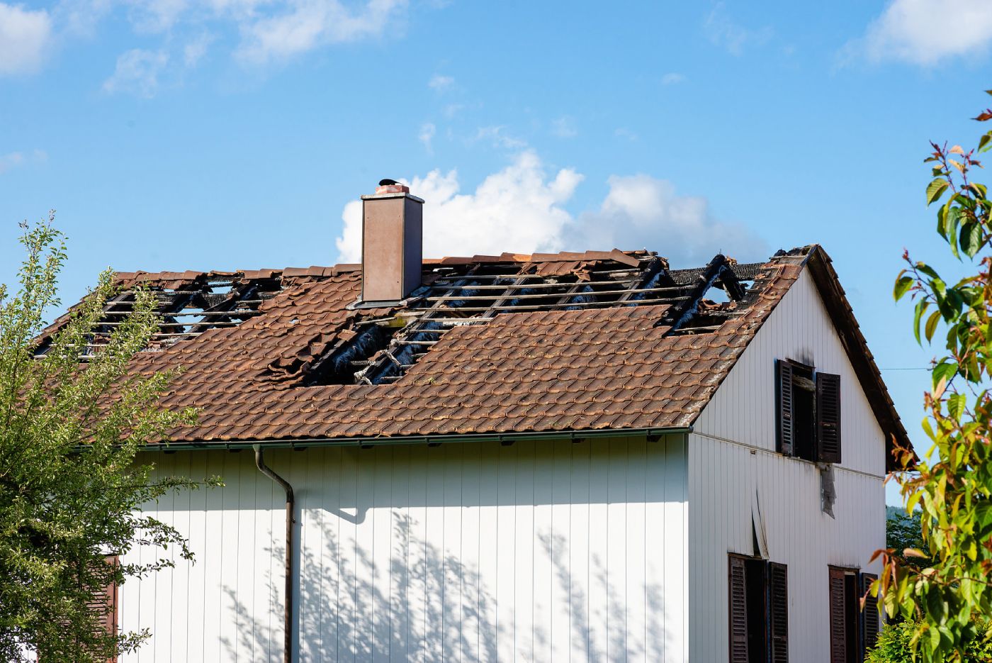 wind-damaged roof with missing shingles